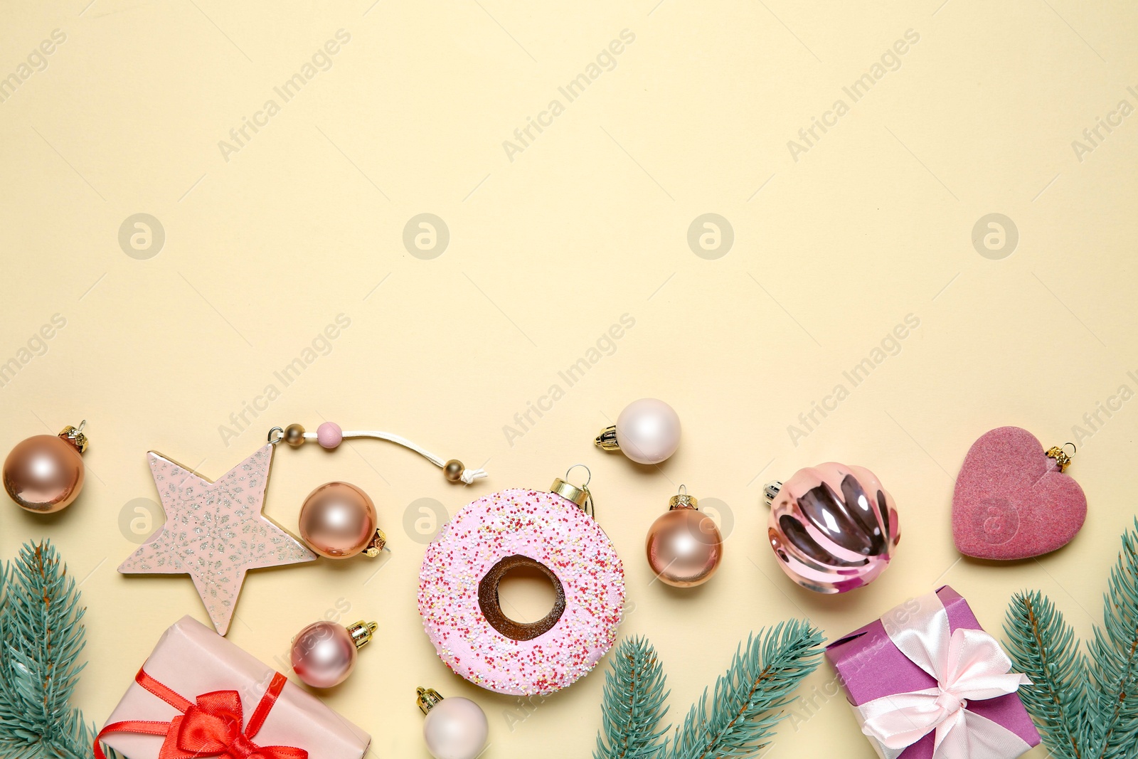 Photo of Flat lay composition with Christmas decor and gift boxes on beige background. Space for text