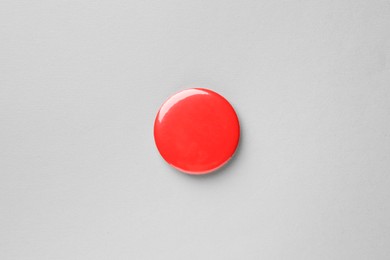 Photo of Blank red button badge on grey background, top view. Mockup for design