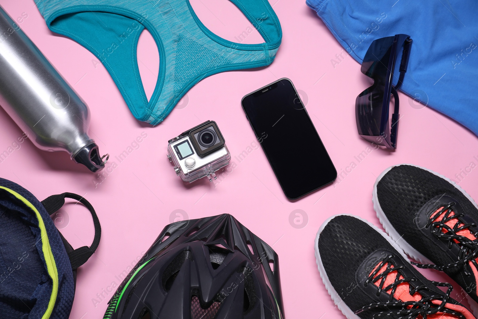 Photo of Flat lay composition with cycling accessories on pink background