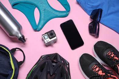 Flat lay composition with cycling accessories on pink background