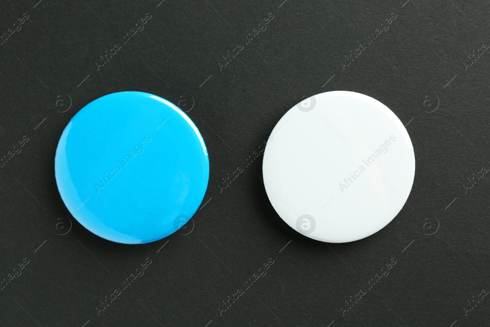 Photo of Button badges on black background, flat lay. Mockup for design