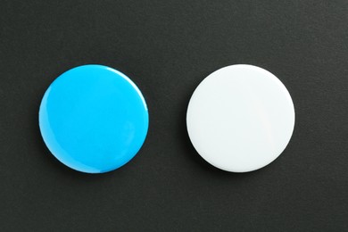 Photo of Button badges on black background, flat lay. Mockup for design