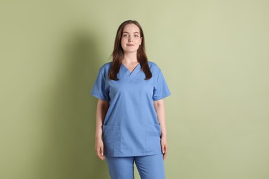 Photo of Portrait of professional nurse on pale green background