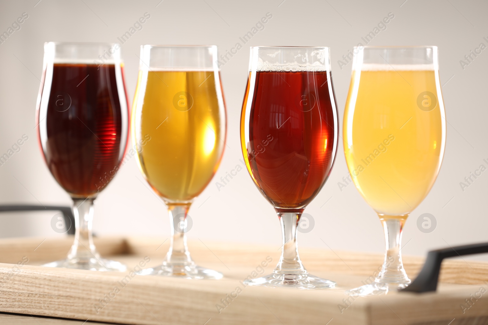 Photo of Glasses with different types of beer on table indoors, closeup