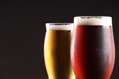 Photo of Glasses with different types of beer on black background, closeup. Space for text