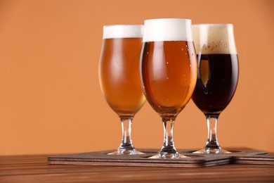 Photo of Glasses with different types of beer on wooden table