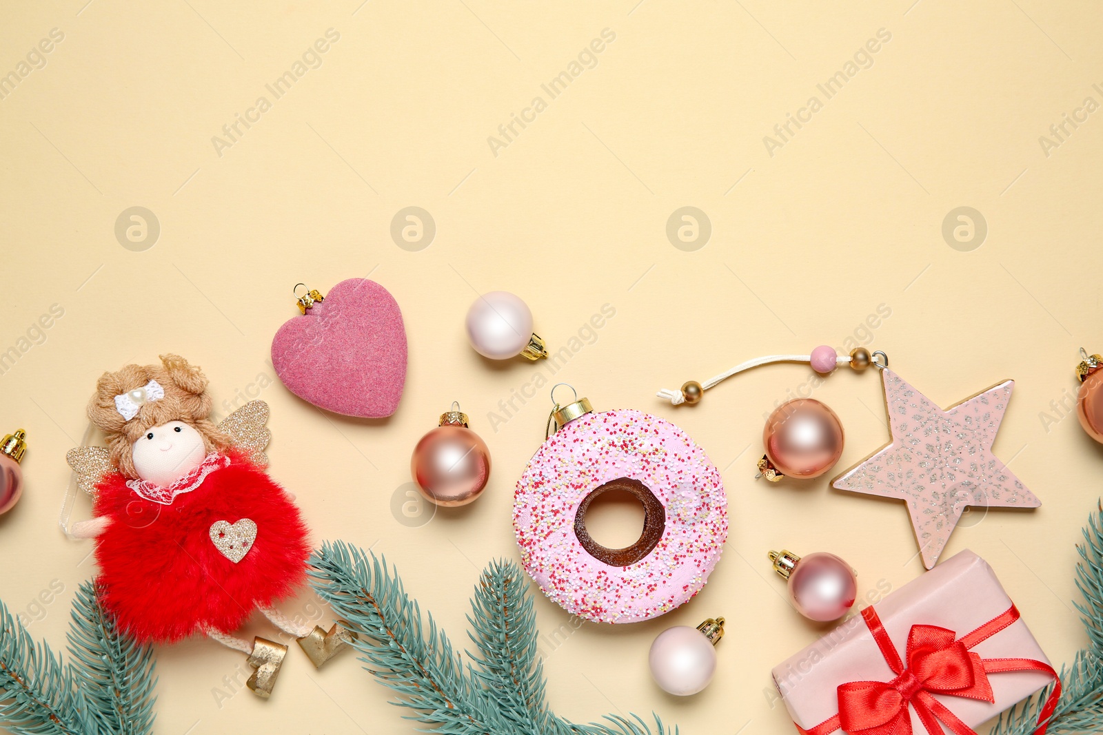 Photo of Flat lay composition with Christmas decor and gift box on beige background. Space for text