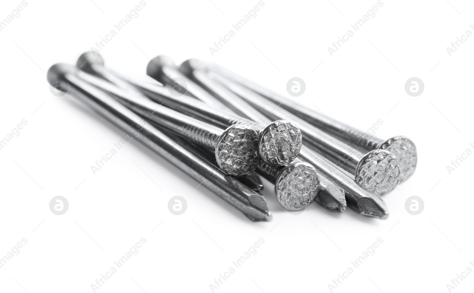 Photo of Pile of metal nails on white background