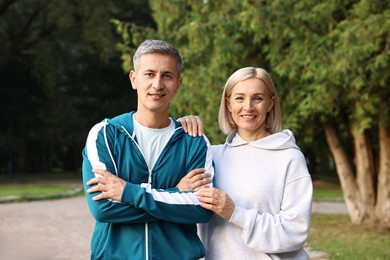 Photo of Portrait of happy couple in sportswear outdoors