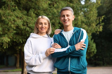 Photo of Portrait of happy couple in sportswear outdoors