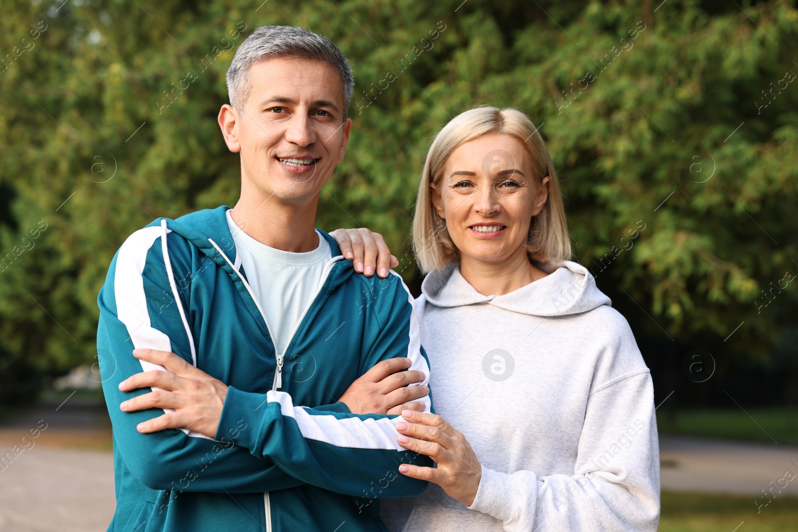 Photo of Portrait of happy couple in sportswear outdoors