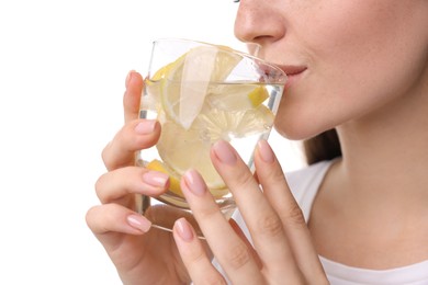 Photo of Woman drinking water with lemon on white background, closeup