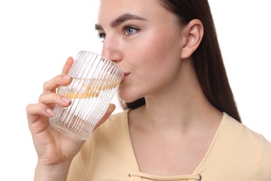 Woman drinking water with lemon on white background, closeup