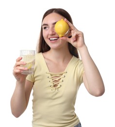 Woman with glass of lemon water and fruit on white background