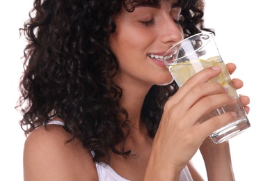 Woman drinking water with lemon on white background, closeup