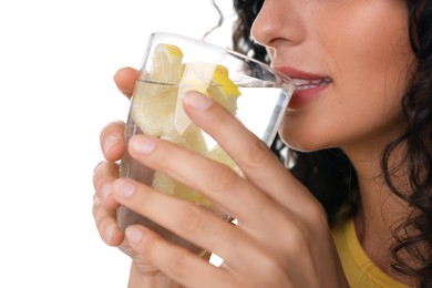 Woman drinking water with lemon on white background, closeup