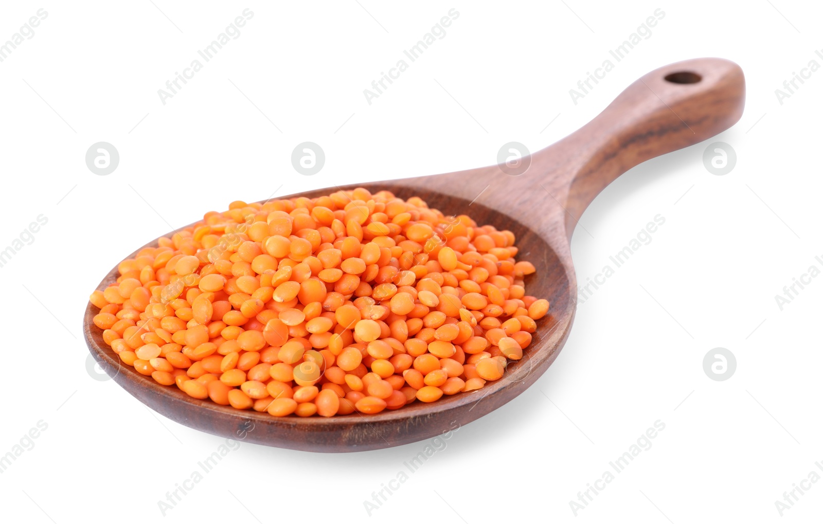 Photo of Raw lentils in spoon isolated on white