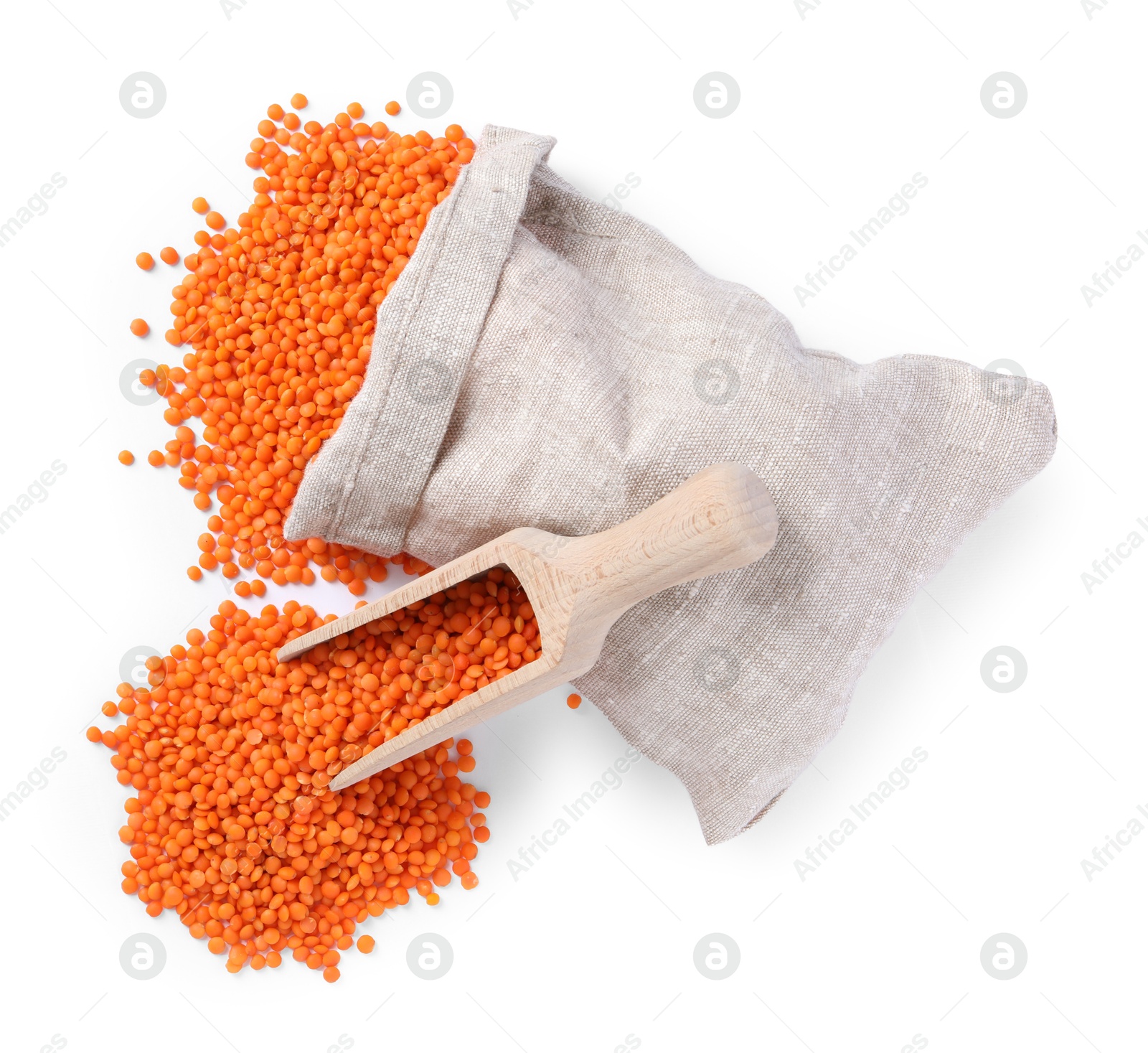 Photo of Raw lentils in burlap with scoop isolated on white, top view