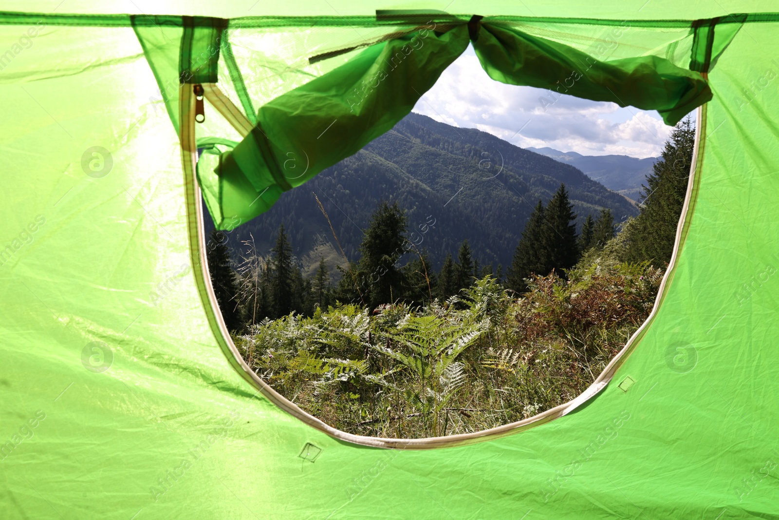 Photo of Beautiful view of mountains through camping tent window