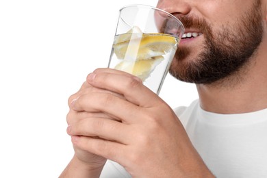 Happy man drinking water with lemon on white background, closeup