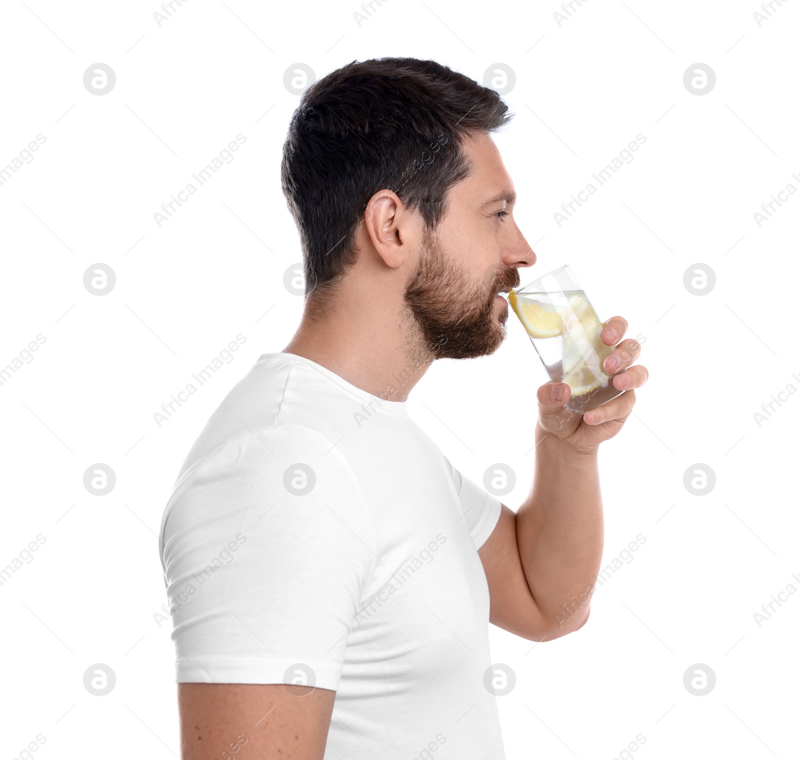 Photo of Handsome man drinking water with lemon on white background