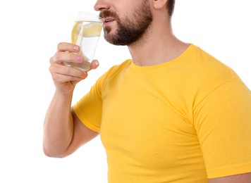 Photo of Man drinking water with lemon on white background, closeup