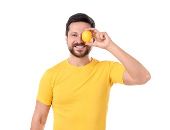 Photo of Happy man covering eye with lemon on white background