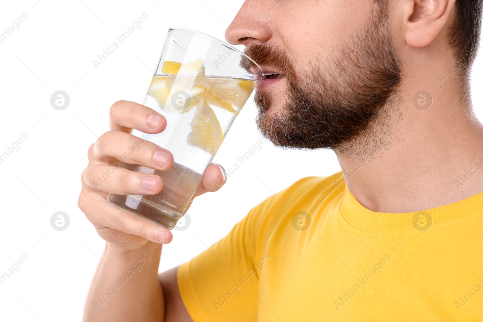 Photo of Man drinking water with lemon on white background, closeup