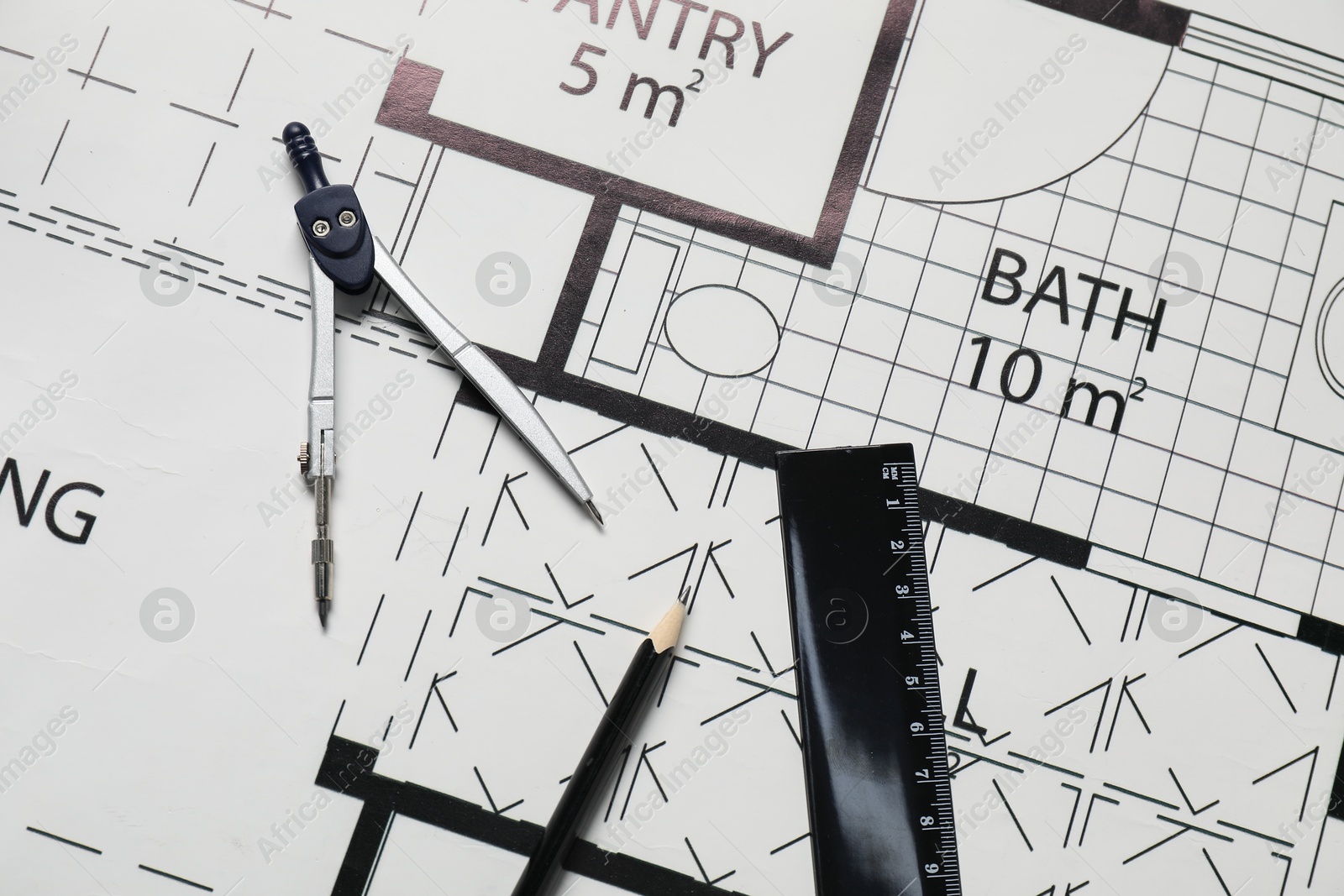 Photo of Ruler, dividers and pencil on different engineering drawings, top view