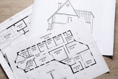 Photo of Different engineering drawings on wooden table, top view