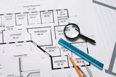 Photo of Pencil, dividers, ruler and magnifying glass on different engineering drawings, top view