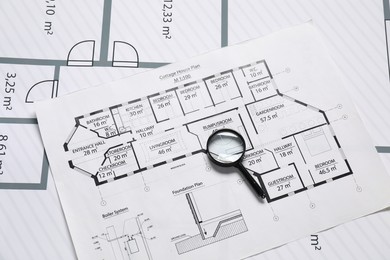 Magnifying glass on different engineering drawings, top view