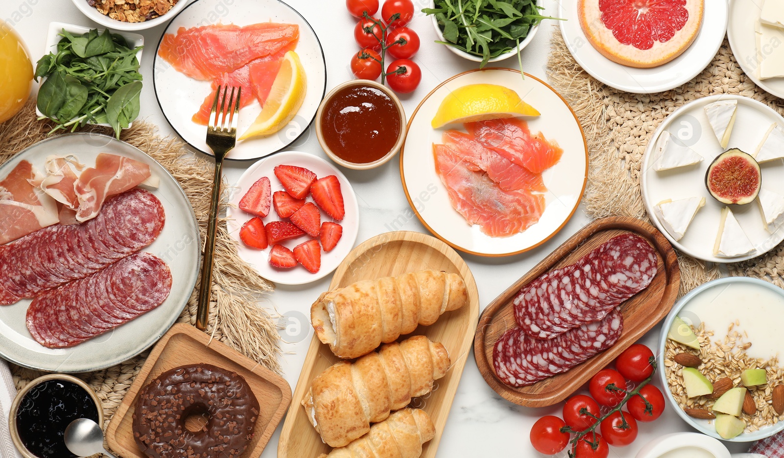 Photo of Different tasty food served for brunch on white marble table, flat lay