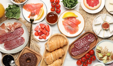 Photo of Different tasty food served for brunch on white marble table, flat lay