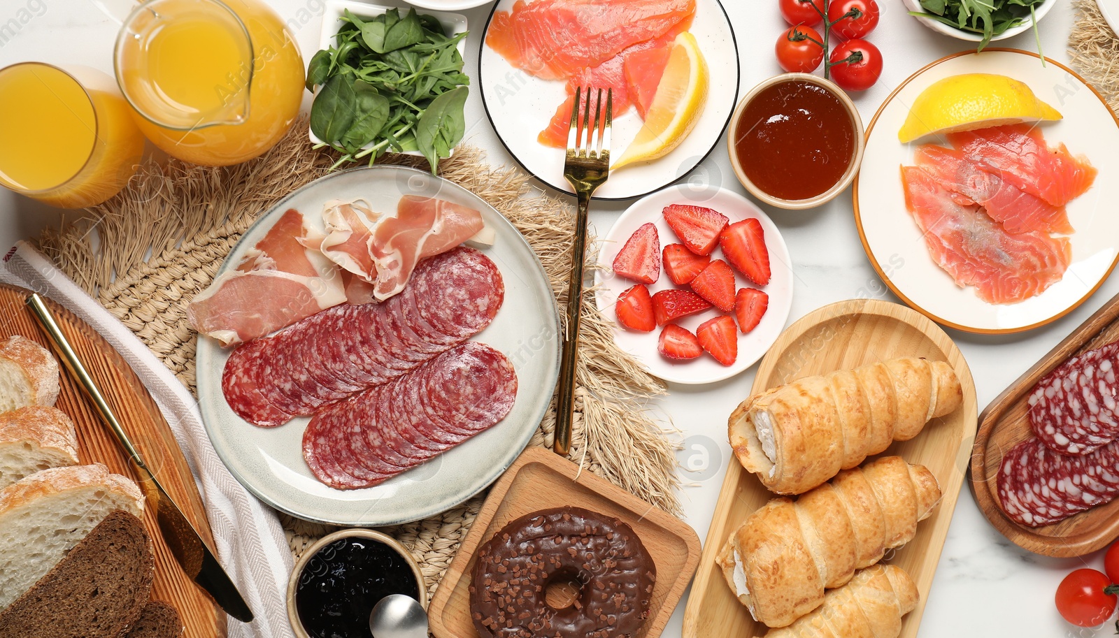 Photo of Different tasty food served for brunch on white marble table, flat lay