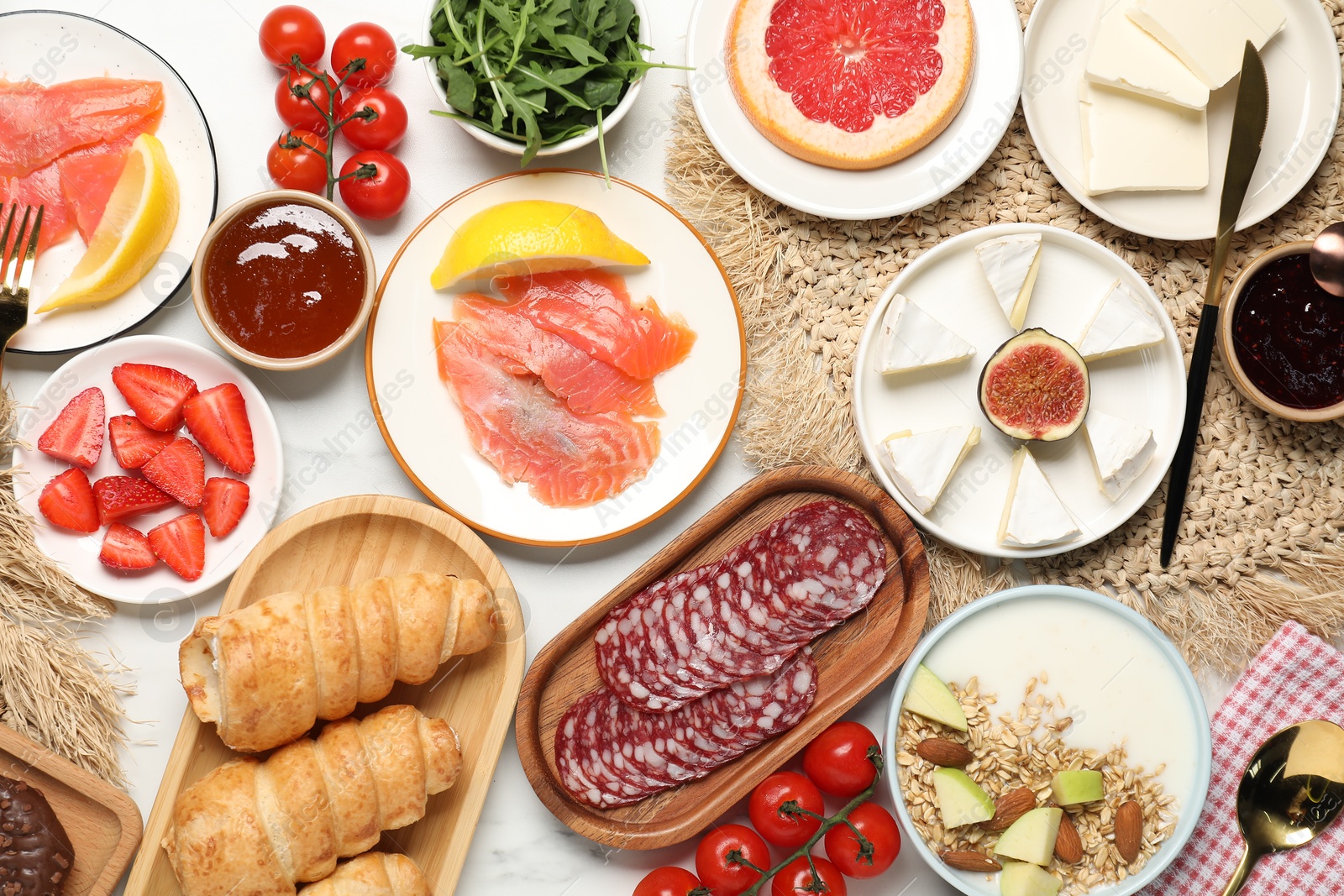 Photo of Different tasty food served for brunch on white marble table, flat lay