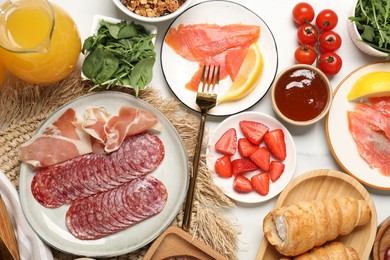 Photo of Different tasty food served for brunch on white marble table, flat lay