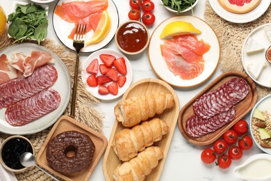 Photo of Different tasty food served for brunch on white marble table, flat lay