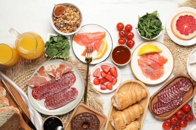 Photo of Different tasty food served for brunch on white marble table, flat lay