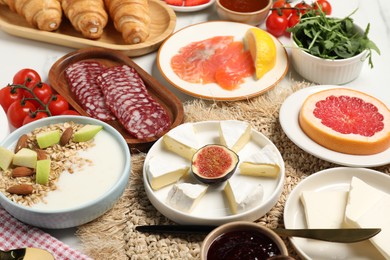 Photo of Different tasty food served for brunch on white table