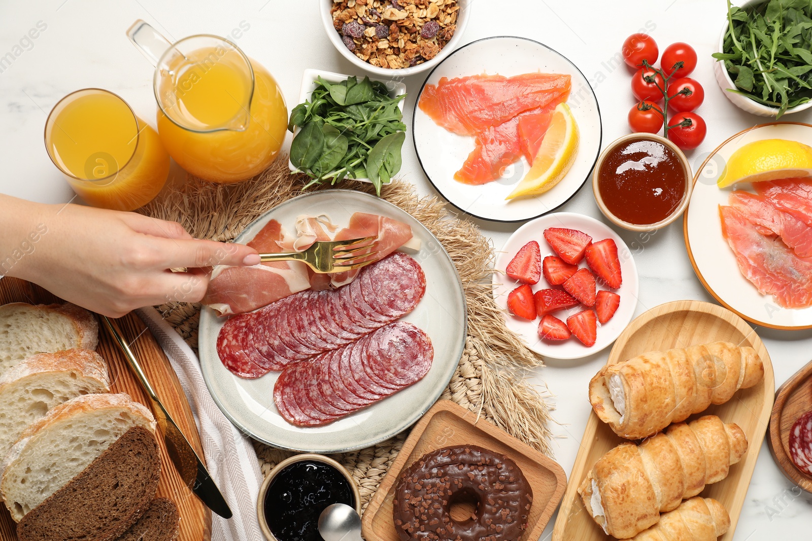 Photo of Woman having brunch at white table, top view