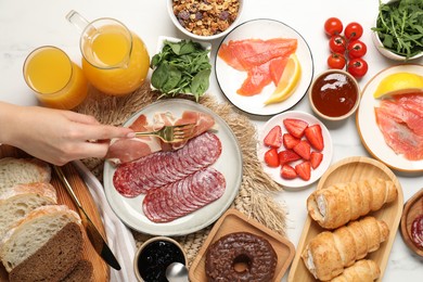 Photo of Woman having brunch at white table, top view