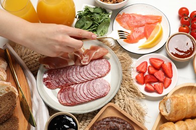 Photo of Woman having brunch at white table, top view