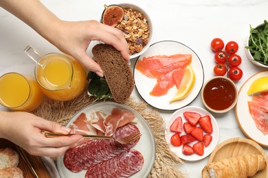 Photo of Woman having brunch at white table, top view