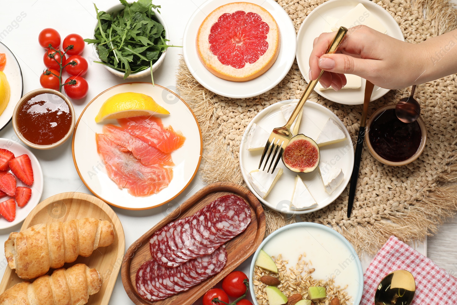 Photo of Woman having brunch at white table, top view