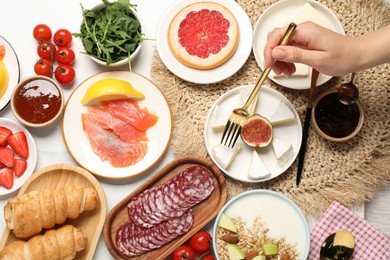 Photo of Woman having brunch at white table, top view