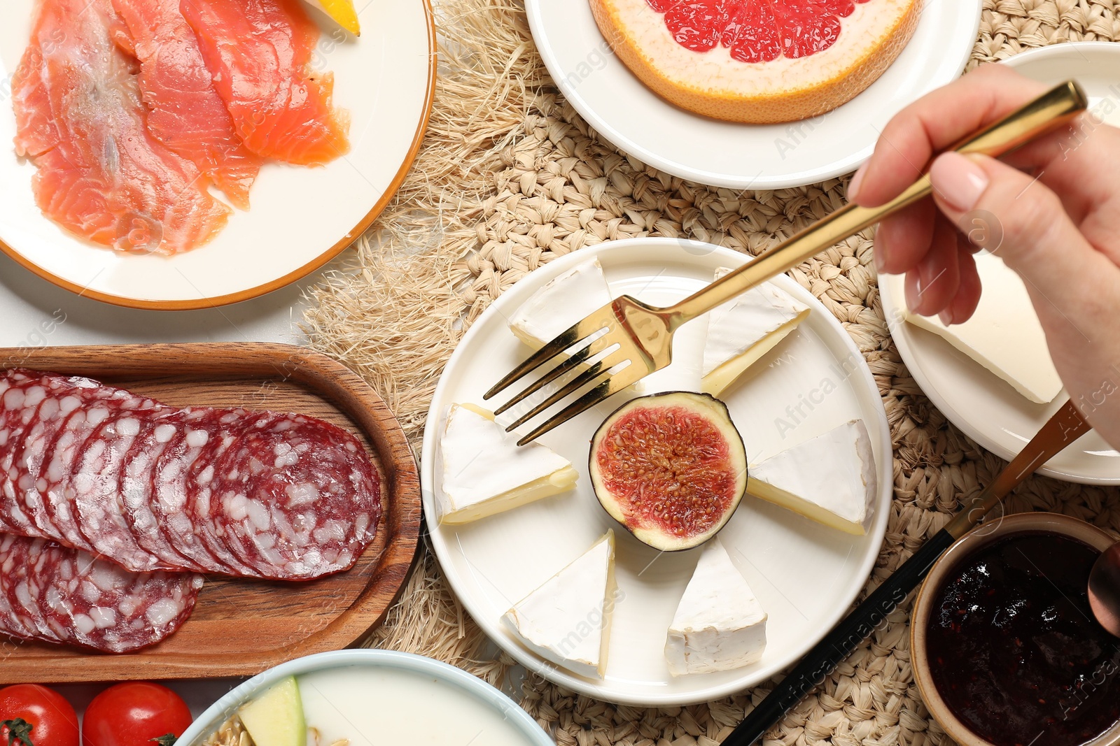 Photo of Woman having brunch at white table, top view