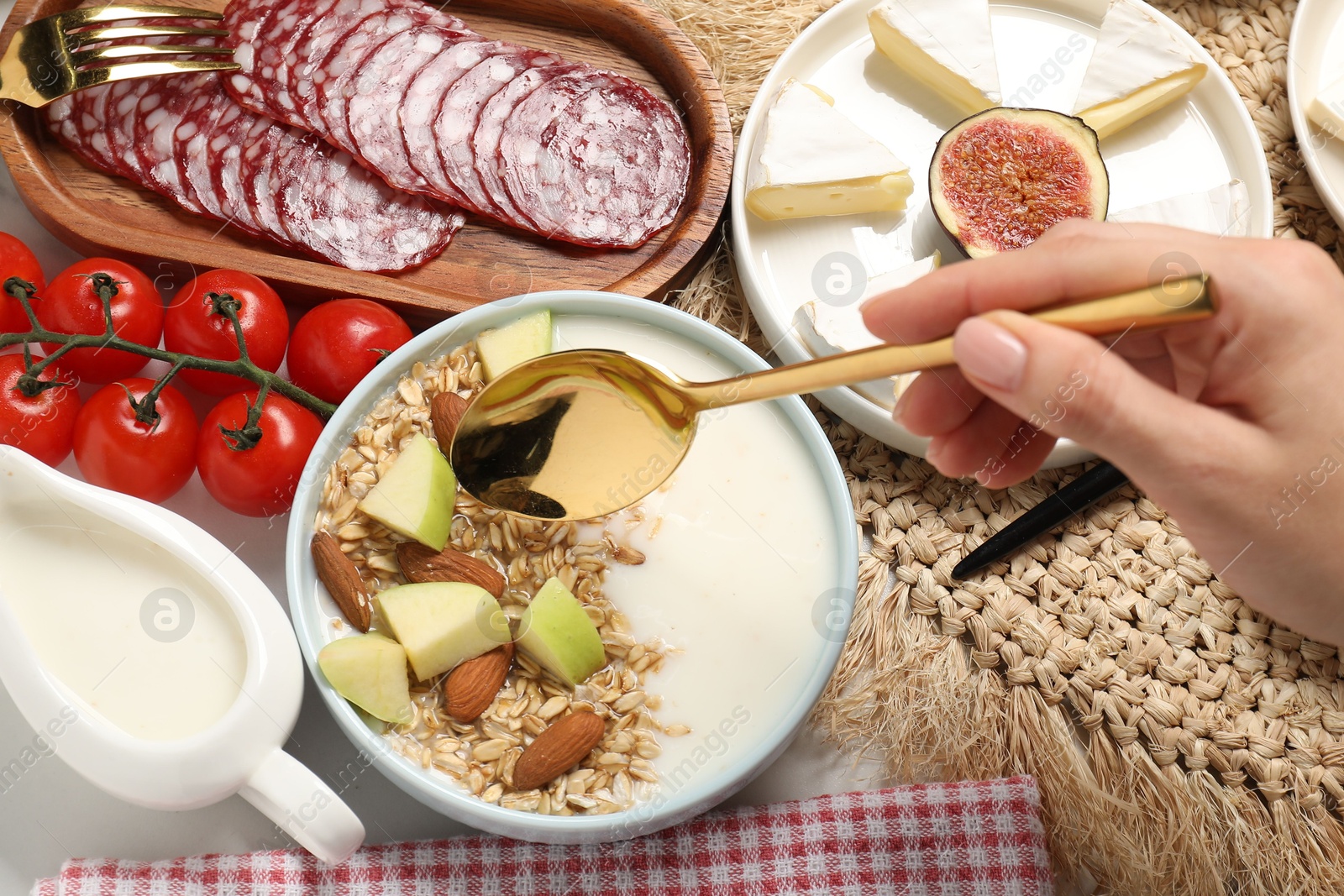 Photo of Woman having brunch at white table, top view