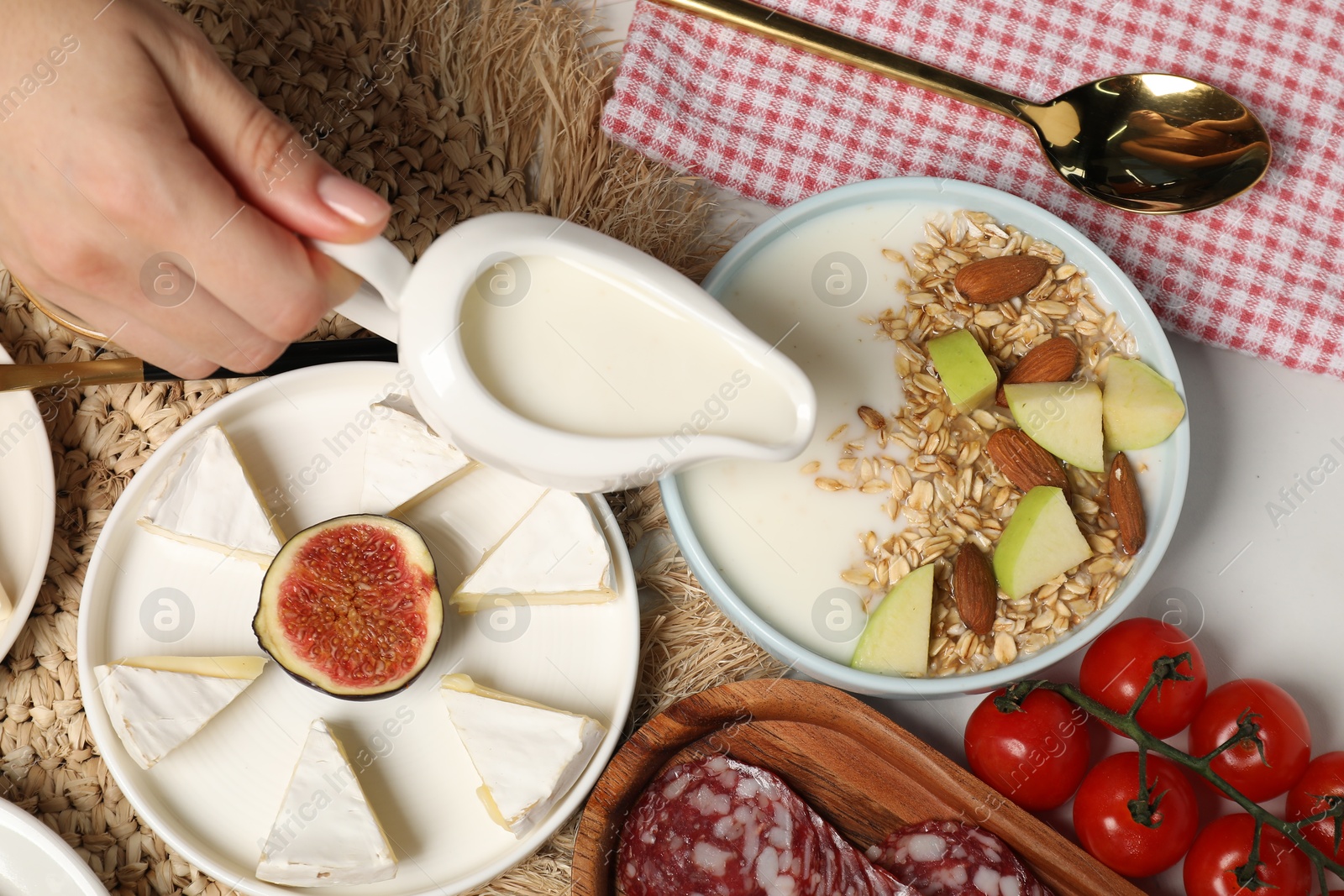 Photo of Woman having brunch at white table, top view