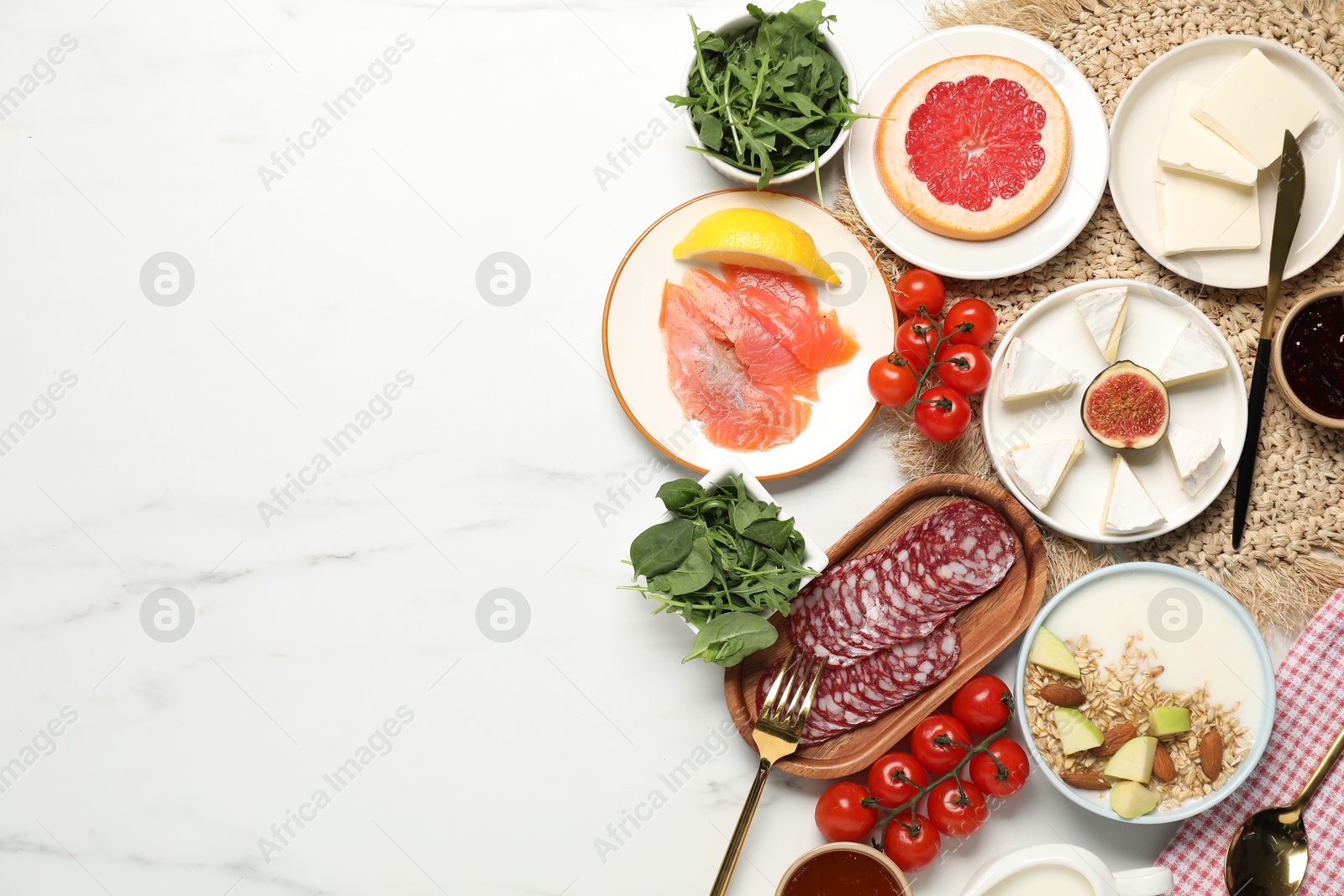 Photo of Different tasty food served for brunch on white marble table, flat lay. Space for text